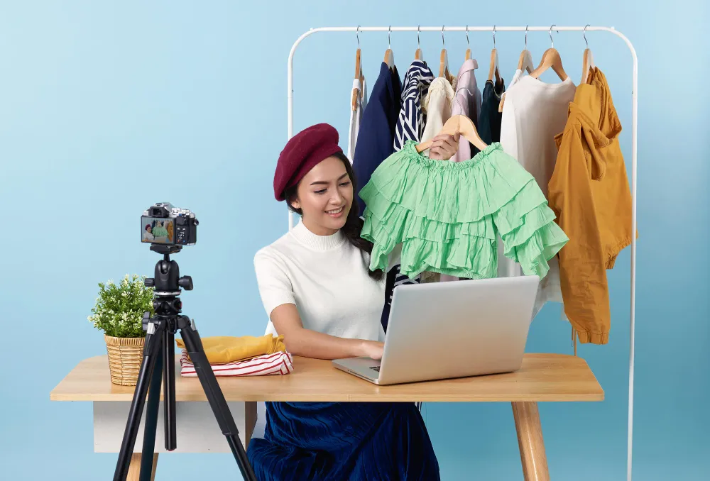 Asian woman live streaming showing clothes front camera sale fashion clothing
